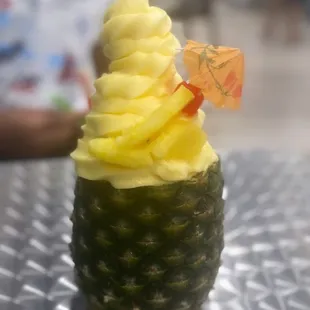a pineapple topped with whipped cream