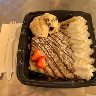 a plate of dessert with ice cream and strawberries