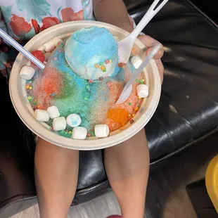 a woman holding a plate of ice cream