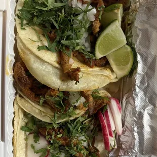 Al Pastor tacos with cilantro, onion, lime, and radish on corn tortillas - combo #2 comes with house fried chips and a beverage