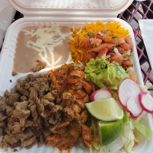 Meat plate special: Steak and chicken with rice and beans with salad and guacamole