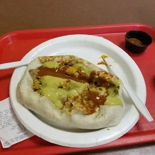 The Manager's Special pork chipotle burrito opened up, slathered in their hot green and red sauces.  $5.99