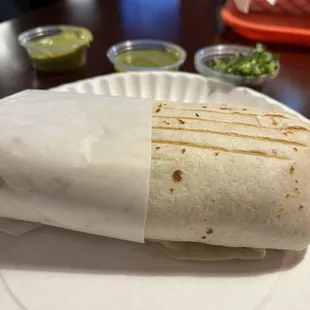 a burrito on a paper plate