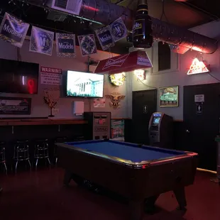 a pool table in the middle of the room