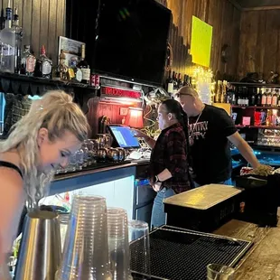 a bartender serving customers