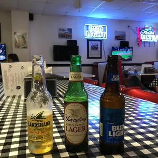 two bottles of beer on a checkered table