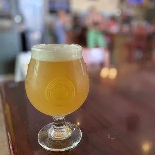 a glass of beer on a bar