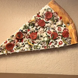 Pizza slice decor in the wall.