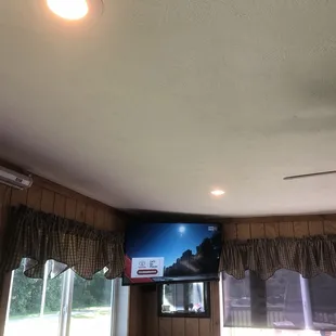 a flat screen tv mounted on the ceiling
