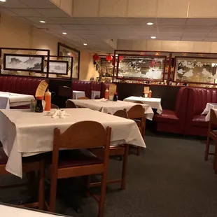 tables and booths with white tablecloths