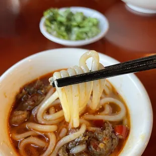 a bowl of noodles and meatballs