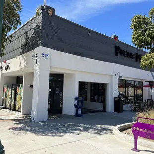 a purple bench in front of a white building