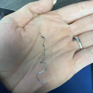 This long metal shaving was inside my egg roll. If swallowed this could cause severe harm. This is not acceptable.