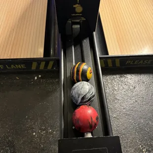 a bowling ball rolling down a conveyor belt