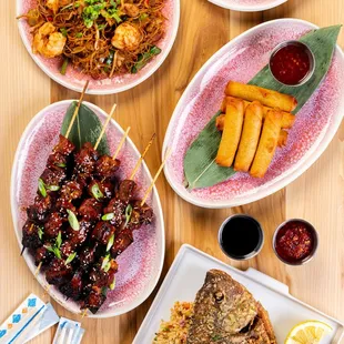 a variety of asian dishes on a wooden table