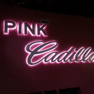 a neon sign for a pink cadillac