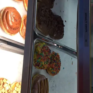 a variety of doughnuts in a display case