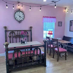 a dining room with pink walls
