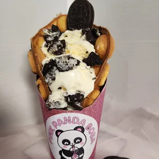 a cup of ice cream and cookies