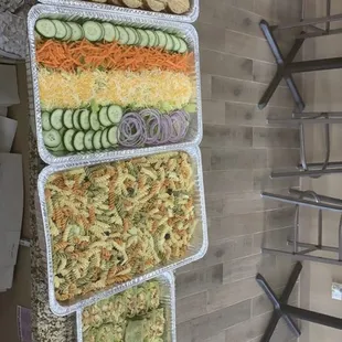 Pink Panini Caters,  what you see is Turkey Sandwiches, Garden Salad, Pasta Salad, Jerk Chicken wraps and Honey garlic Chicken wraps