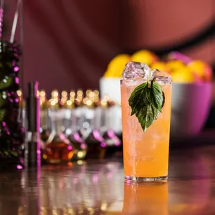 a glass of orange juice on a bar