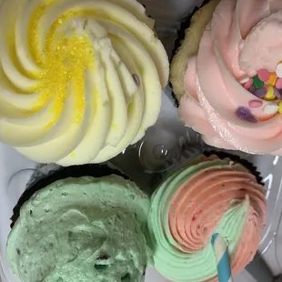 a variety of frosted cupcakes