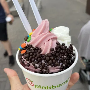 a person holding a cup of ice cream