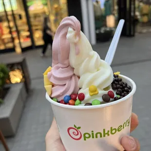 a person holding a cup of ice cream