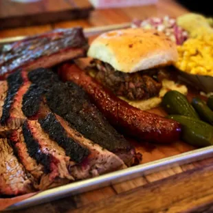 Brisket, sausage, chopped beef sandwich, pork ribs, bacon Mac and cheese, potato salad and cole slaw!! On Instagram @CheatDay_SA