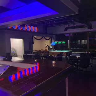 a pool table and neon lights