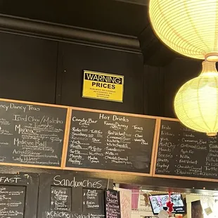 Chalkboard menu &amp; odd sign about prices. There are none posted, so ‍