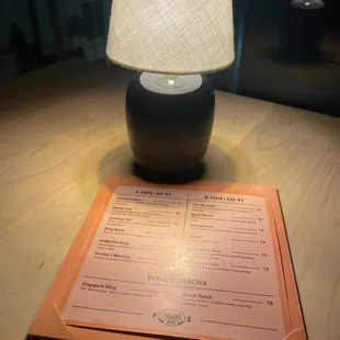 a menu and a lamp on a table