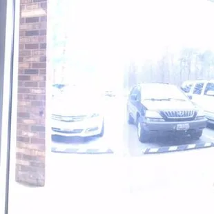 Stool bench seating over looking parking lot. Three tables behind us, two high tops (2 seats) and one round table for five.