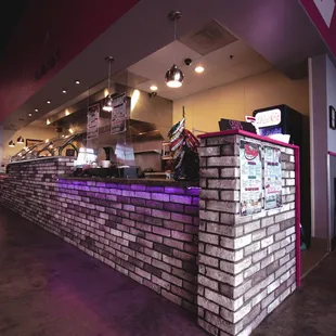 a brick wall with neon lights
