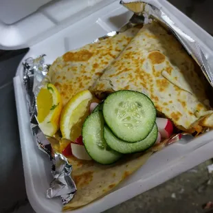 a close up of a sandwich in a styrofoam container