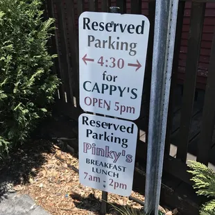 reserved parking signs in front of a house