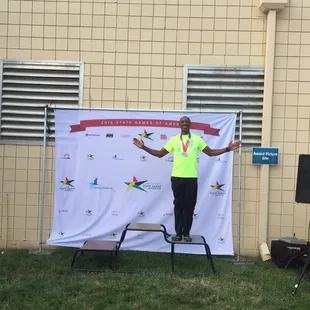 Receiving silver medal for 400 meter dash men&apos;s 45-49.
