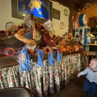 a toddler standing in front of a display