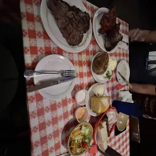 Porterhouse, cornbread, baked potatoes, bbq chicken and ribs