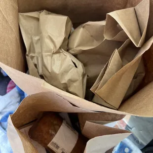 a brown paper bag full of food