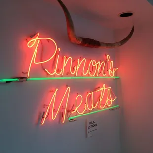 a neon sign on a wall
