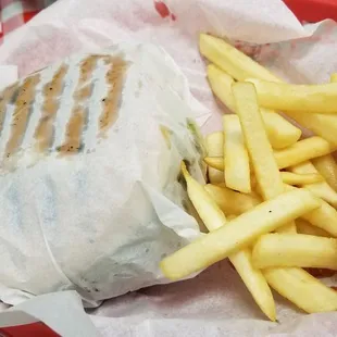 a plate of french fries and a sandwich