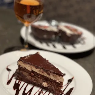 a piece of chocolate cake and a glass of wine