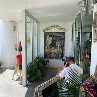 a man and a woman sitting on a porch