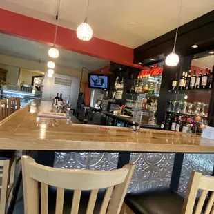 a bar with chairs and a television