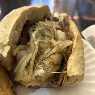 The key is grilled onions, slices of steak not chopped steak