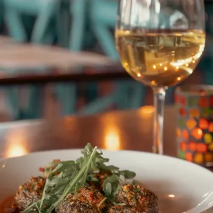 a plate of food and a glass of wine