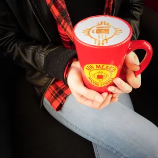 a woman holding a cup of coffee