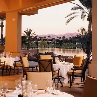 a view of a lake and palm trees
