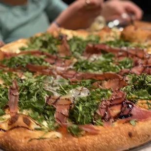 Pizza!  Burrata, prosciutto, arugula, and balsamic reduction.  Tasty, perfect crust, and worth it.  Yes.